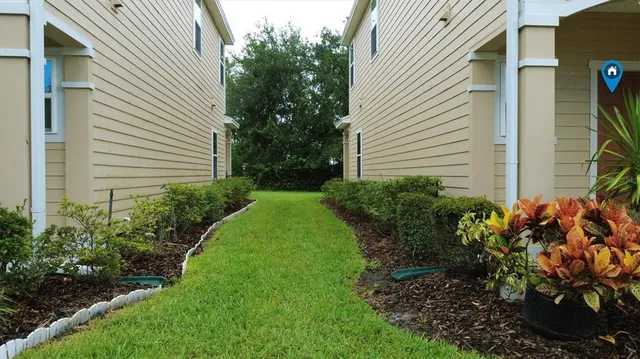 a view of an house with backyard space and garden