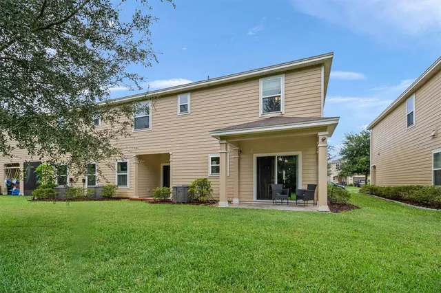 an aerial view of a residential apartment building with a yard and garden