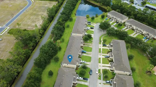 an aerial view of residential houses with outdoor space and river