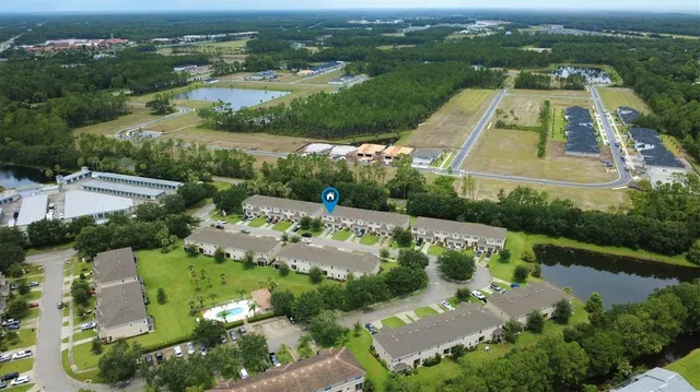 an aerial view of a house with a garden and lake view