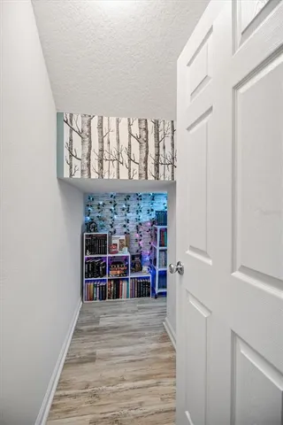 a view of a room with wooden floor and windows