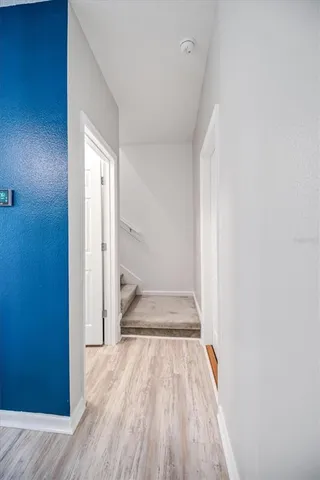 a view of a hallway with wooden floor