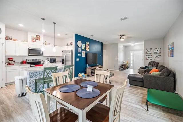 a living room with furniture and kitchen view