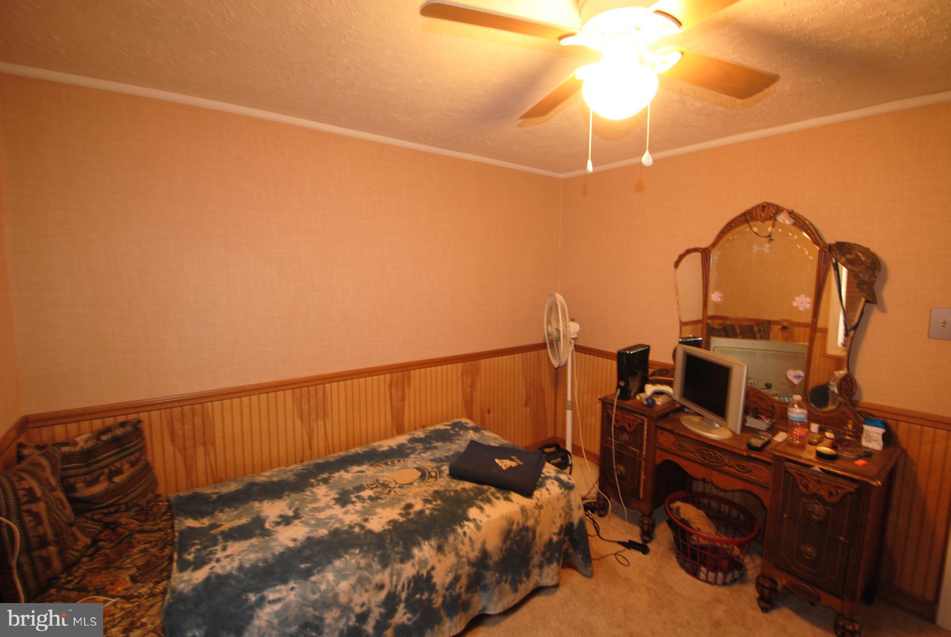 345 Sinking Spring Lane Gore, VA 22637 - Photo 13 of 30 a bedroom with bed and a chandelier