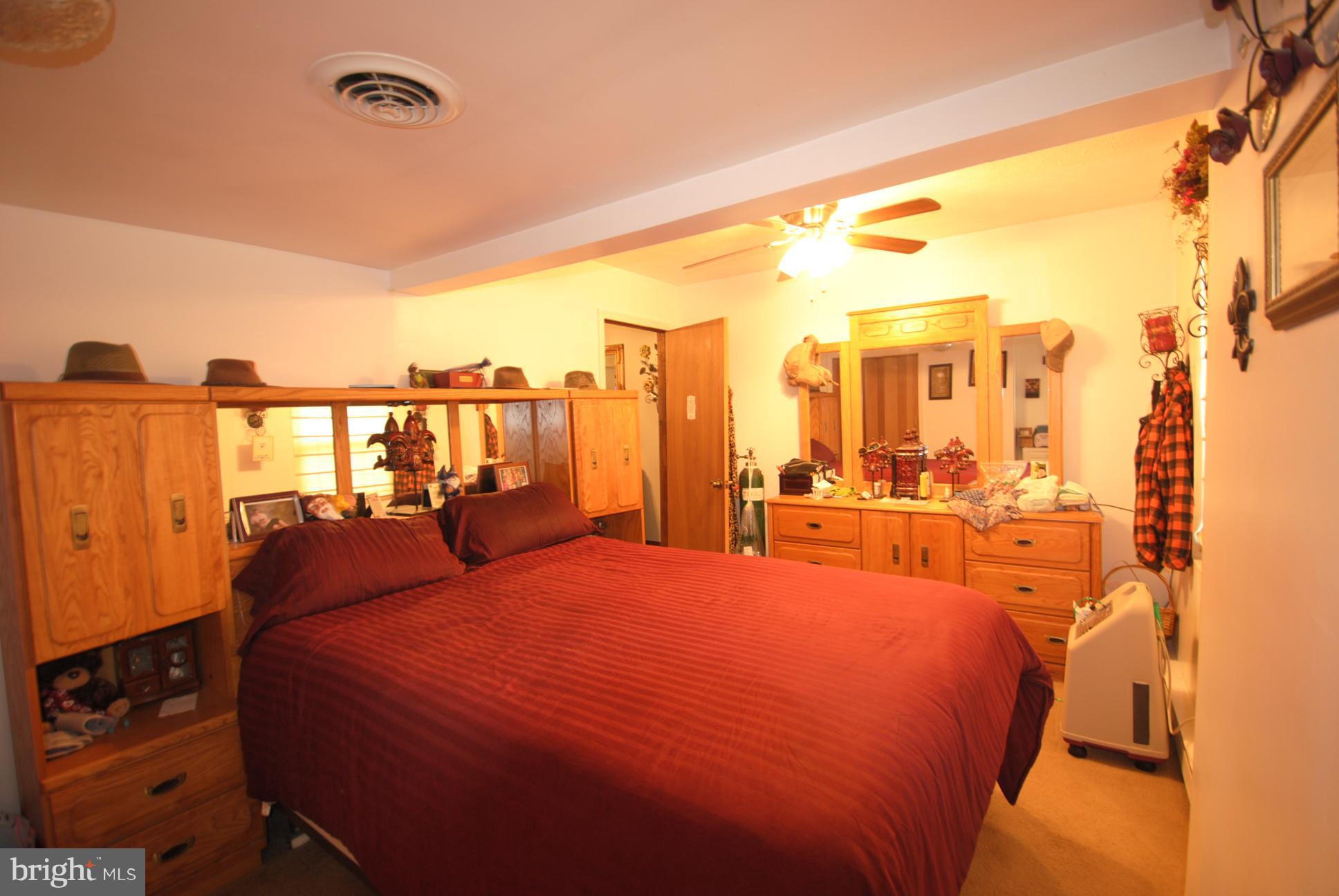 345 Sinking Spring Lane Gore, VA 22637 - Photo 15 of 30 a large bedroom with a bed and large windows