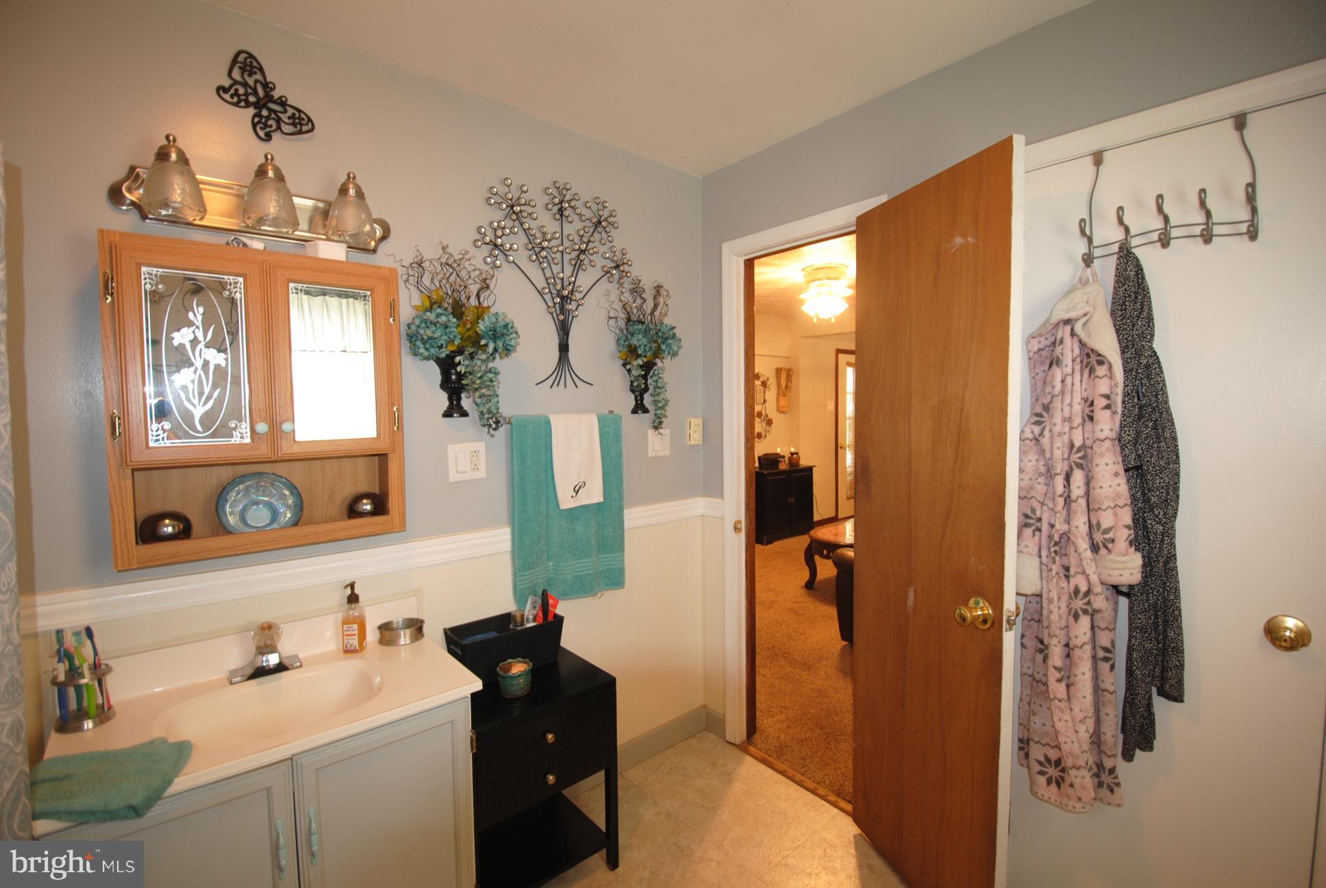 345 Sinking Spring Lane Gore, VA 22637 - Photo 17 of 30 a bathroom with a sink vanity granite and a mirror