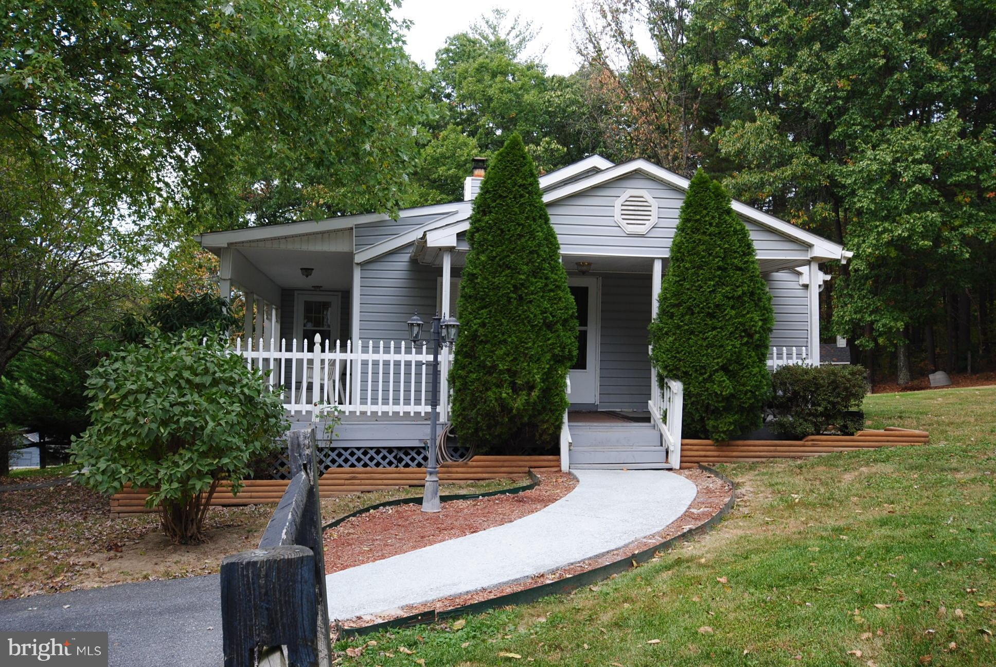 345 Sinking Spring Lane Gore, VA 22637 - Photo 3 of 30 a front view of a house with garden