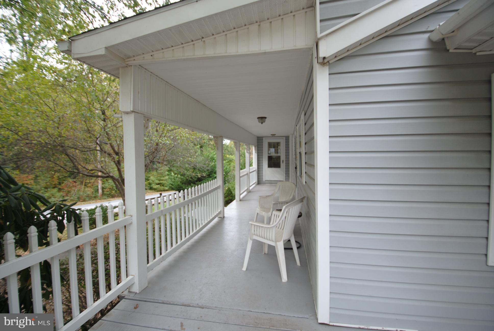 345 Sinking Spring Lane Gore, VA 22637 - Photo 4 of 30 a view of a porch with a table and chairs
