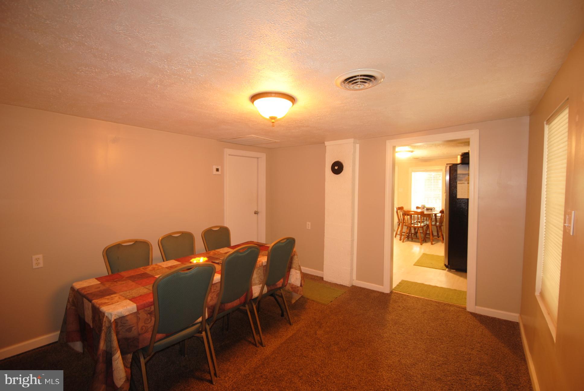 345 Sinking Spring Lane Gore, VA 22637 - Photo 7 of 30 a view of a dining room with furniture and a chandelier