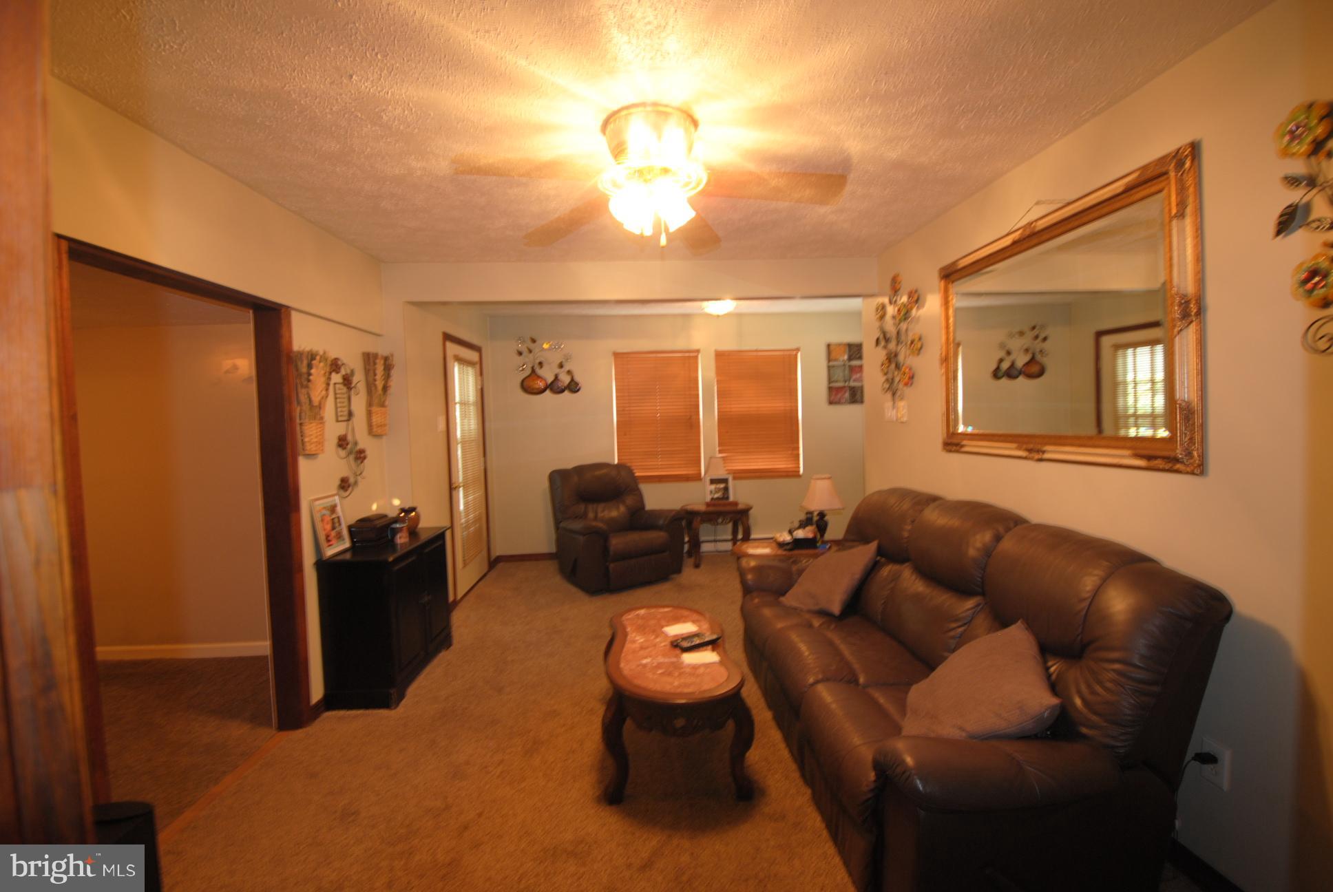 345 Sinking Spring Lane Gore, VA 22637 - Photo 10 of 30 a living room with furniture and a chandelier