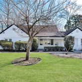 a front view of a house with a yard garage and outdoor seating