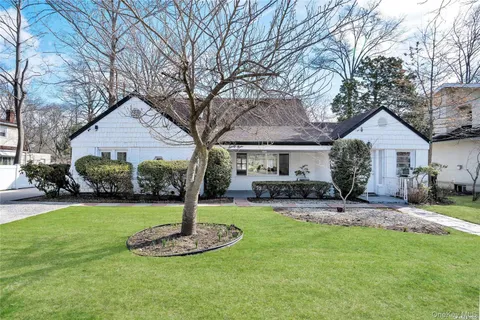 a front view of a house with a yard garage and outdoor seating