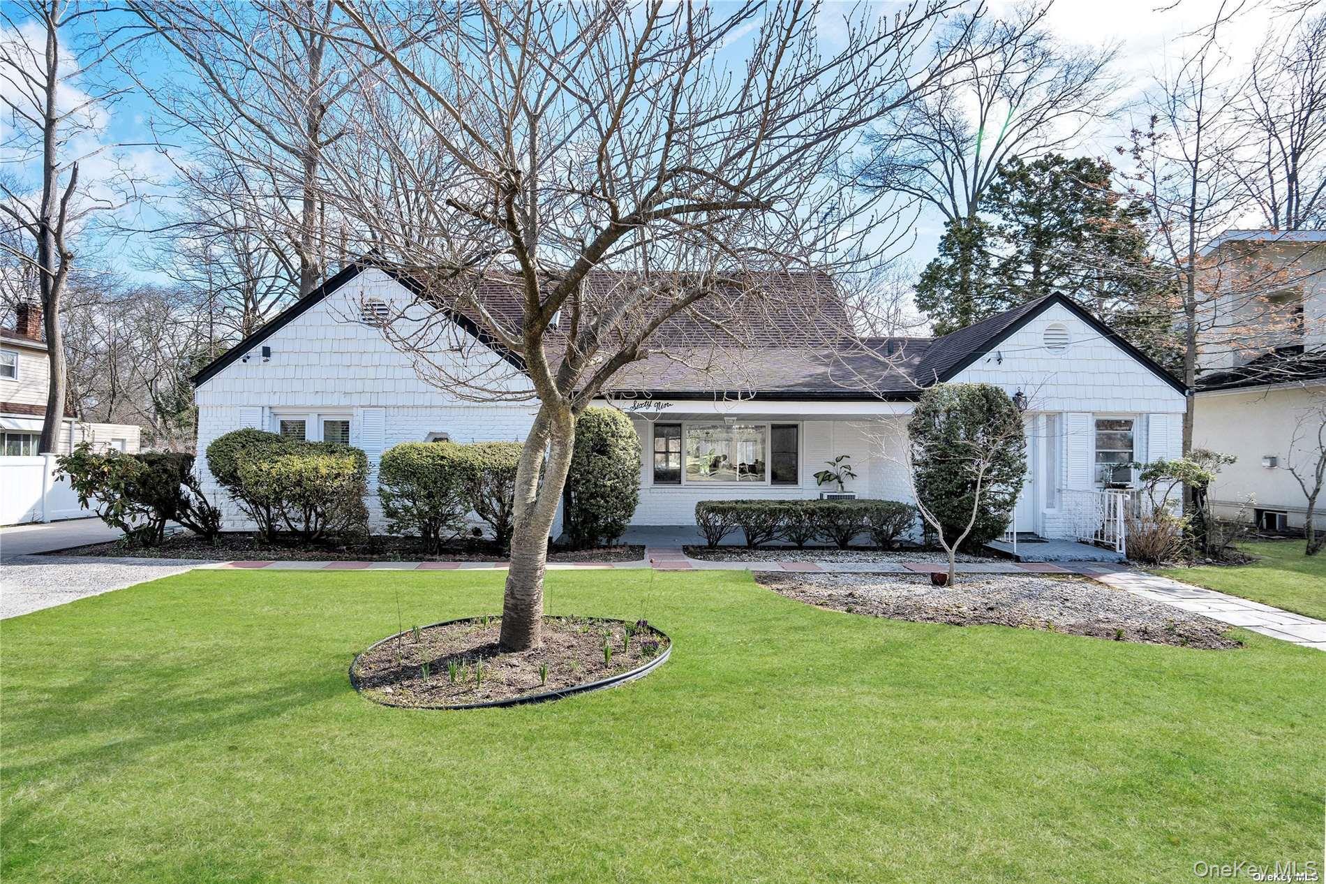 a front view of a house with a yard garage and outdoor seating