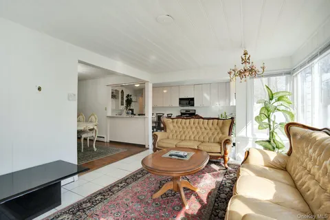 a living room with furniture and a chandelier