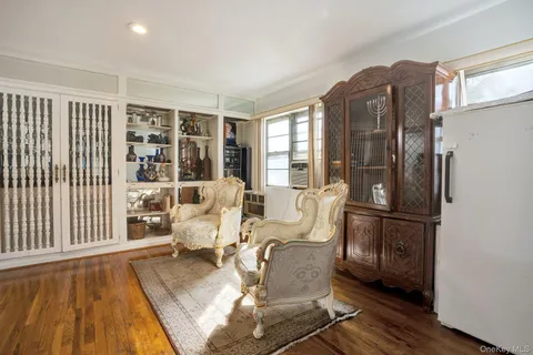 a living room with furniture windows and wooden floor
