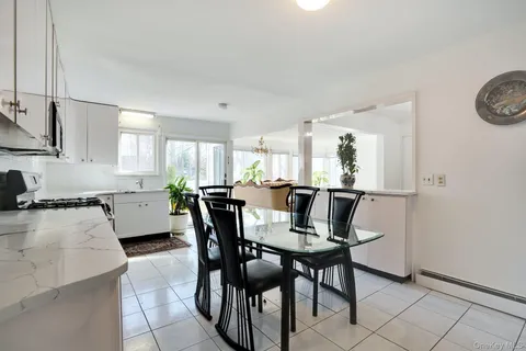 a view of a dining room with furniture and a window