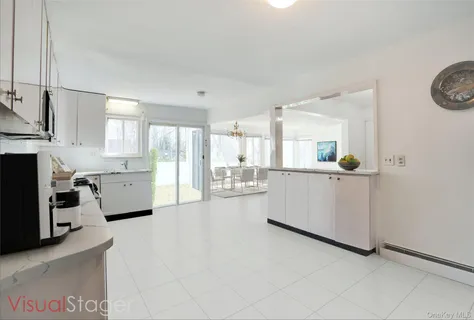 a kitchen with stainless steel appliances a refrigerator sink and cabinets