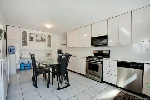 a kitchen with stainless steel appliances a stove a sink island and a refrigerator