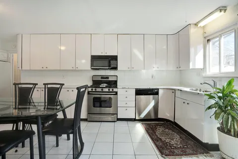 a kitchen with granite countertop a stove a sink and a microwave