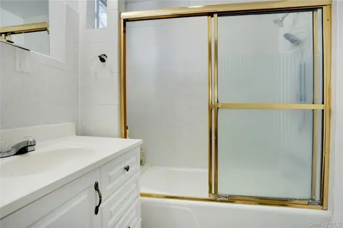 a bathroom with a shower and a sink