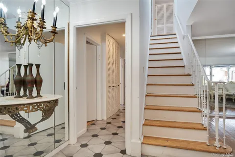 a view of a hallway with wooden floor and entryway