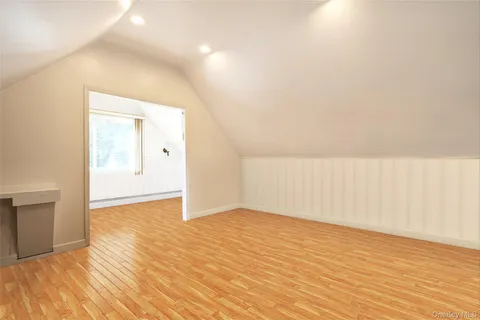 a view of an empty room and wooden floor