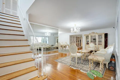 a view of a livingroom with furniture staircase and kitchen view