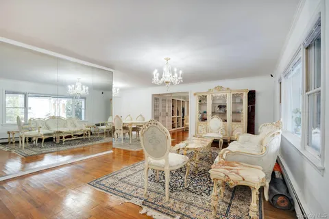 a living room with furniture and a chandelier