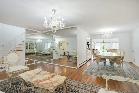 a room with dining table and a chandelier