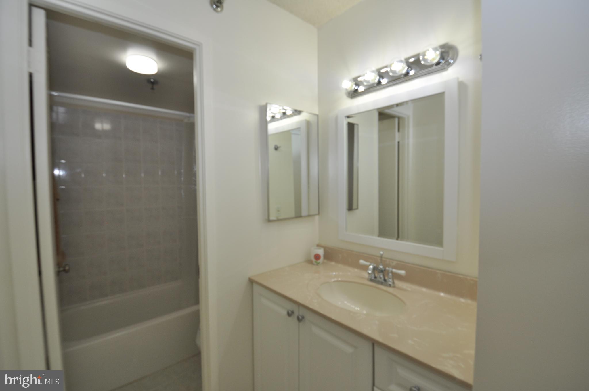 5911 Edsall Road, Unit 403 Alexandria, VA 22304 - Photo 15 of 29 a bathroom with a sink double vanity and a mirror
