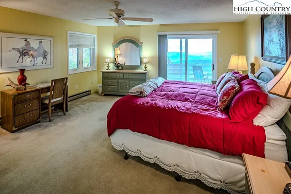 a bedroom with a bed and a large mirror on dresser