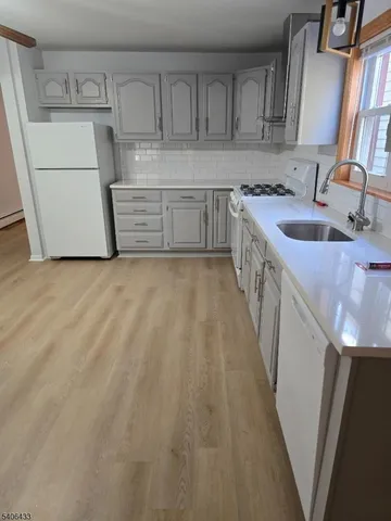 a kitchen with kitchen island a sink stove and cabinets
