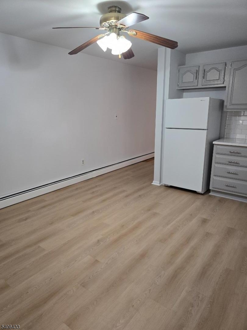 110 Elm Street Newark, NJ 07105 - Photo 2 of 11 a view of a storage & utility room with a refrigerator