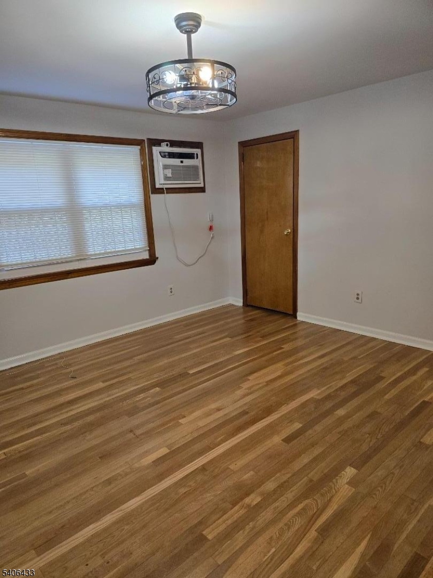 110 Elm Street Newark, NJ 07105 - Photo 4 of 11 a view of an empty room with wooden floor and a window
