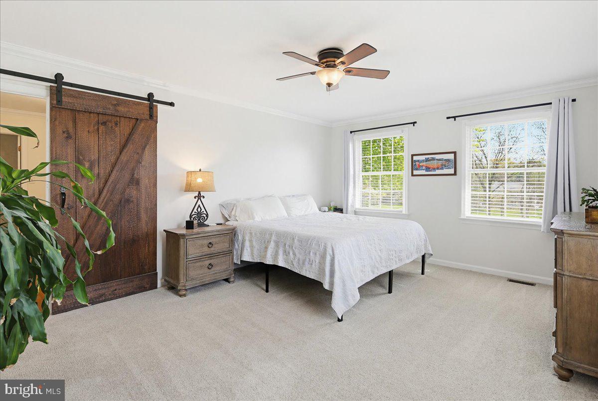 20128 Gunpowder Road Manchester, MD 21102 - Photo 21 of 66 a bedroom with a bed and a chandelier