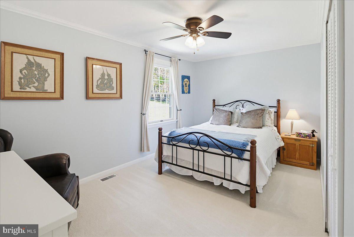 20128 Gunpowder Road Manchester, MD 21102 - Photo 25 of 66 a bedroom with a large bed and a chandelier