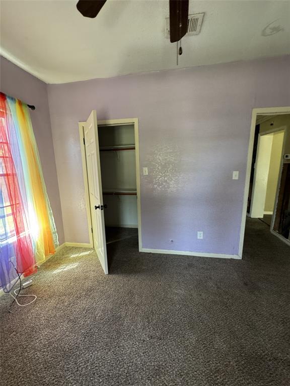 803 Ripley Avenue Ennis, TX 75119 - Photo 34 of 40 Carpeted room featuring a ceiling fan, a closet with a bi-fold door, and a window