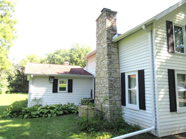 2118 Grand Detour Road Dixon, IL 61021 - Photo 3 of 16 a front view of a house with a garden