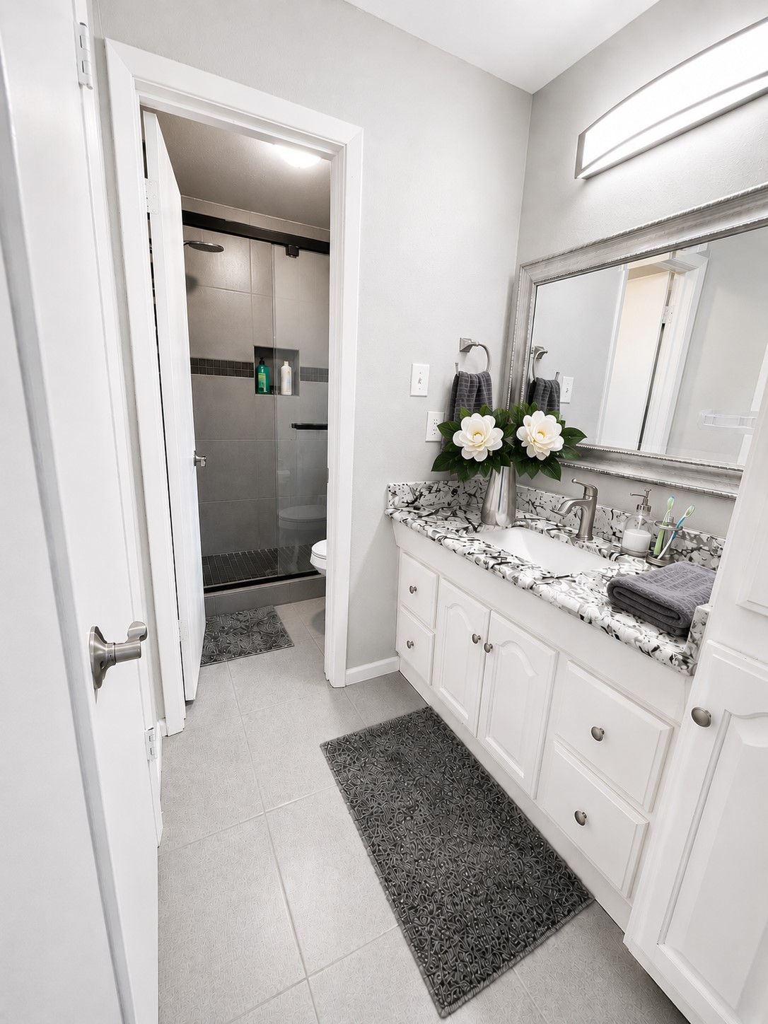 23907 Spring Mill Lane Spring, TX 77373 - Photo 19 of 28 The bathroom has been fully updated. Granite countertops, shower tiled all the way up, and beautiful glass shower doors, etc.