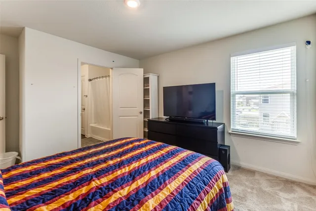 a bedroom with a bed and a television