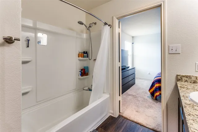 a bathroom with a granite countertop sink toilet and a mirror