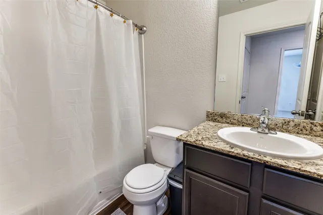 a bathroom with a tub shower and a sink