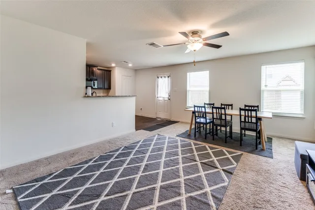 a very nice looking dining room with wooden floor