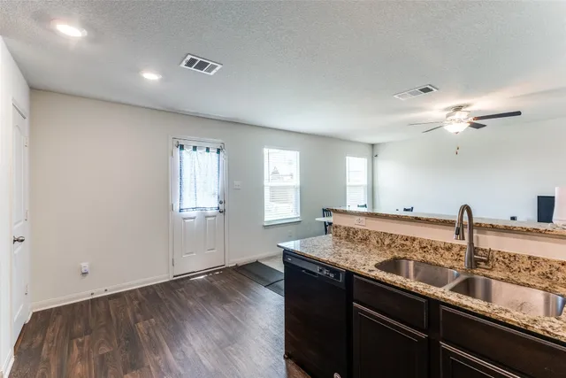 a kitchen with stainless steel appliances granite countertop a stove a refrigerator and a oven