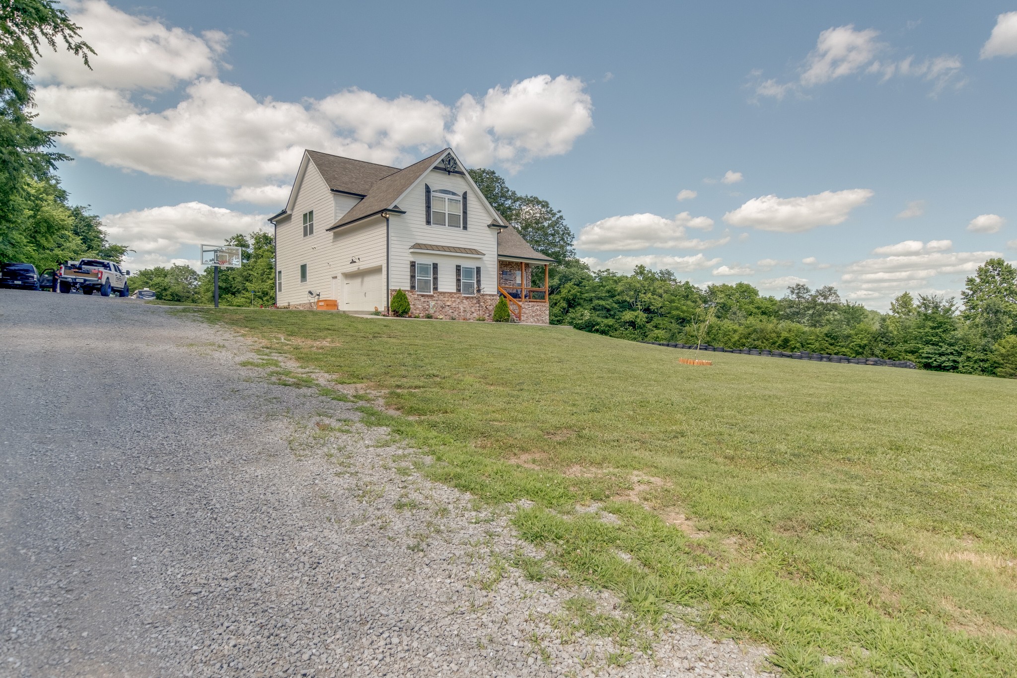 1755 Chicken Road Lebanon, TN 37090 - Photo 3 of 34 a front view of a house with a garden and trees