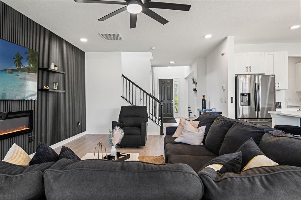 5945 Newberry Pnes Avenue Wesley Chapel, FL 33545 - Photo 13 of 55 a living room with furniture and a ceiling fan