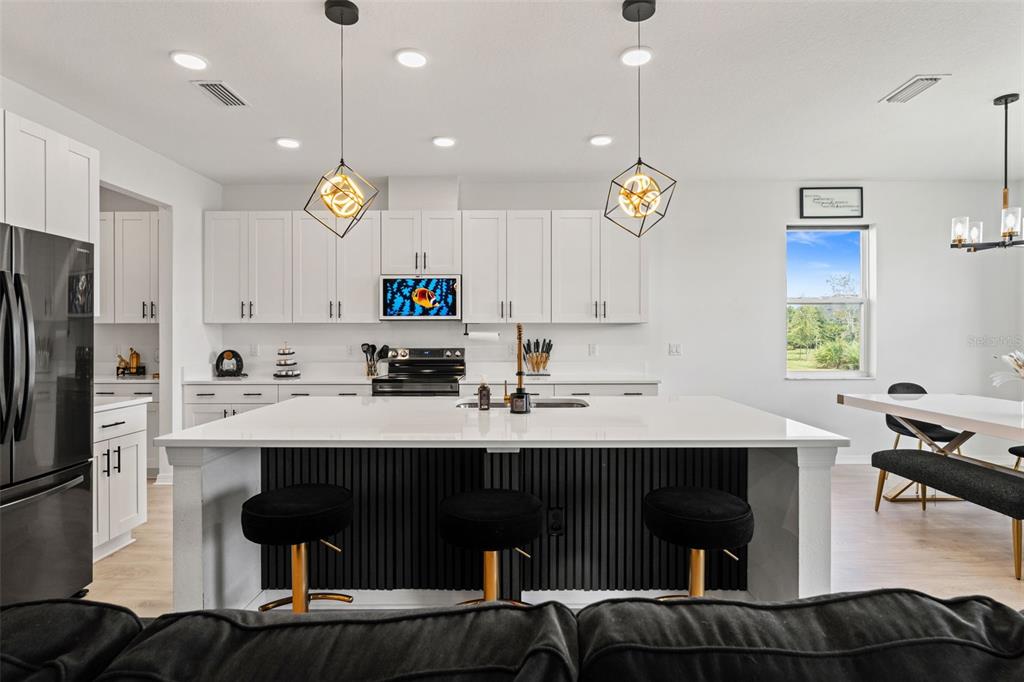 5945 Newberry Pnes Avenue Wesley Chapel, FL 33545 - Photo 16 of 55 a kitchen with a sink cabinets and window
