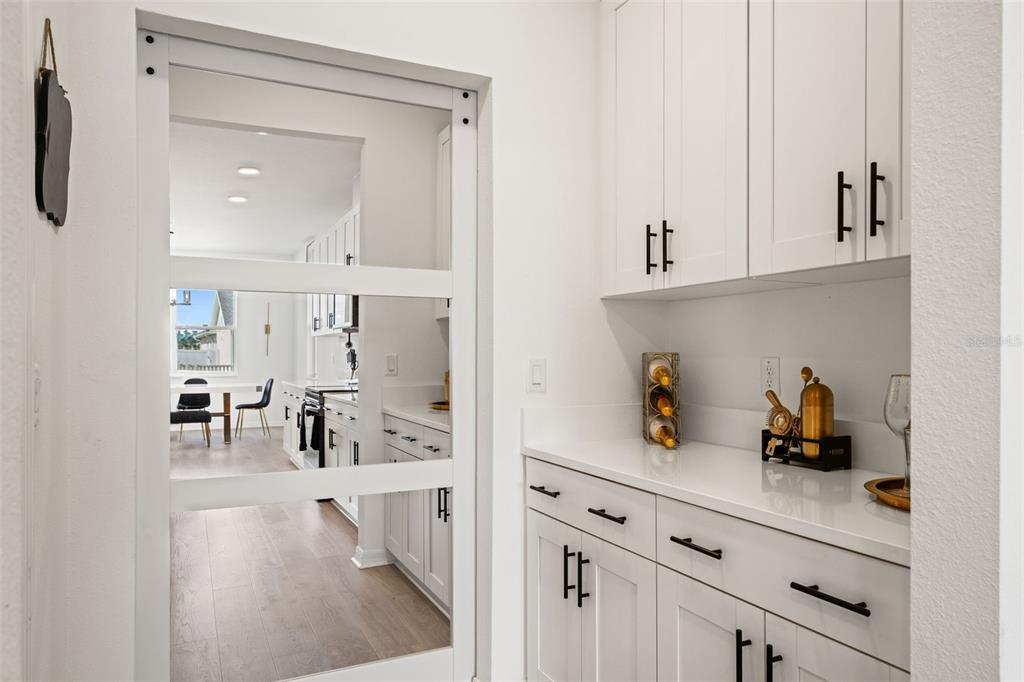 5945 Newberry Pnes Avenue Wesley Chapel, FL 33545 - Photo 22 of 55 a kitchen with white cabinets and window