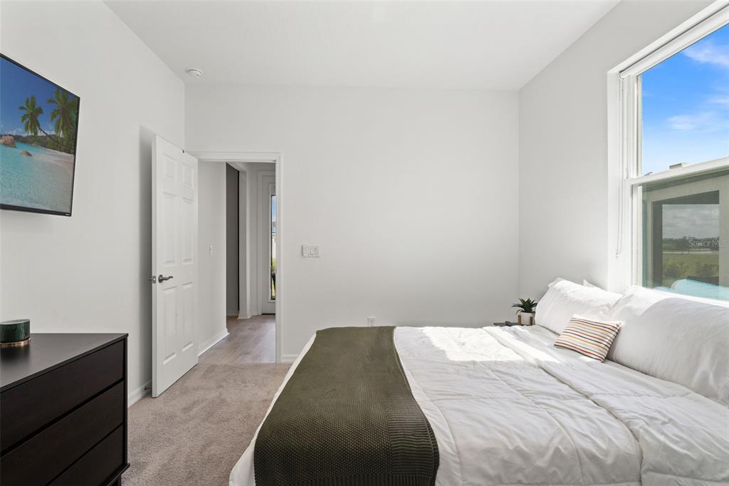 5945 Newberry Pnes Avenue Wesley Chapel, FL 33545 - Photo 26 of 55 a bedroom with a bed and a potted plant