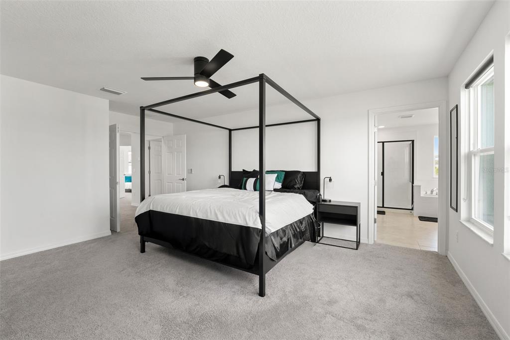 5945 Newberry Pnes Avenue Wesley Chapel, FL 33545 - Photo 32 of 55 a bedroom with a bed lamp closet and window